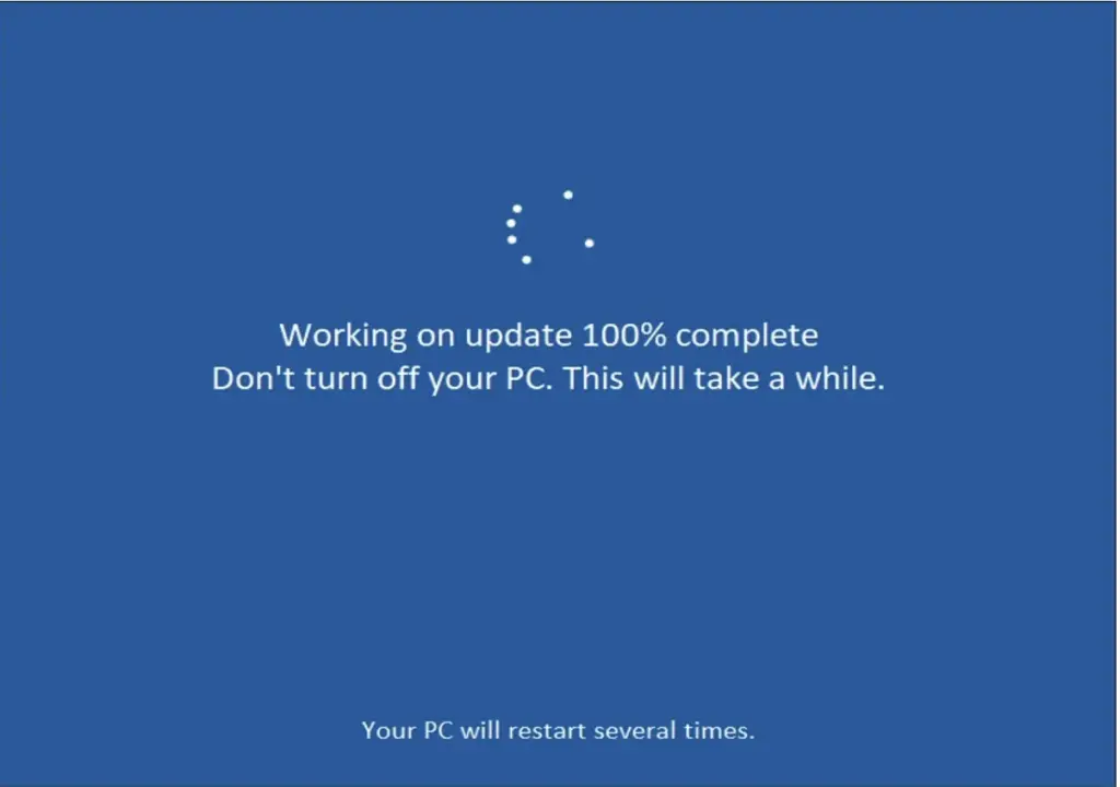 Ein blauer Computerbildschirm zeigt die Meldung an: Arbeiten am Update 100% abgeschlossen. Schalten Sie Ihren PC nicht aus. Dies wird eine Weile dauern. Ihr PC wird mehrmals neu gestartet - ein häufiger Anblick, wenn Sie Einstellungen wie So ändern Sie die Sprache und das Tastaturlayout in Windows 11 und Windows 10 ändern.